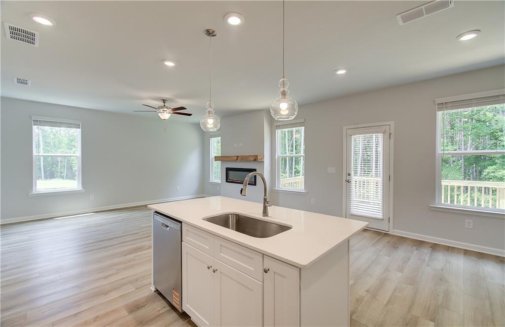 84 Hydrangea Circle Fairburn, GA 30213 - Photo 13 of 23 a kitchen that has a sink a window and wooden floor