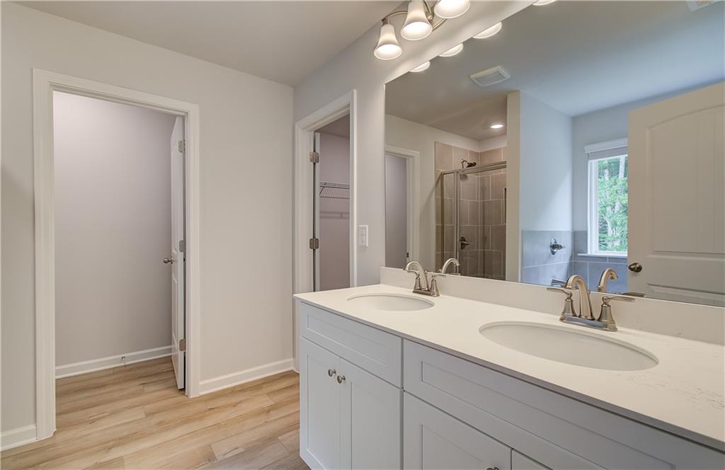 84 Hydrangea Circle Fairburn, GA 30213 - Photo 21 of 23 a bathroom with a double vanity sink and a mirror