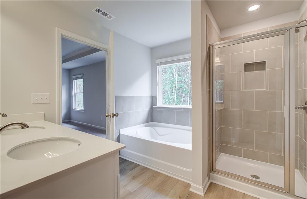 84 Hydrangea Circle Fairburn, GA 30213 - Photo 22 of 23 a bathroom with a bathtub and a sink