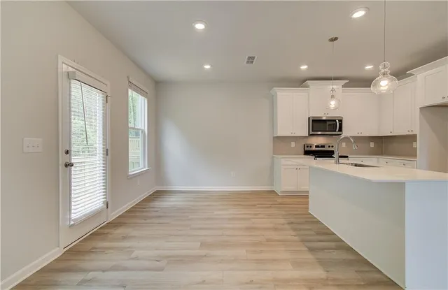 a kitchen with stainless steel appliances granite countertop a stove a sink and a refrigerator