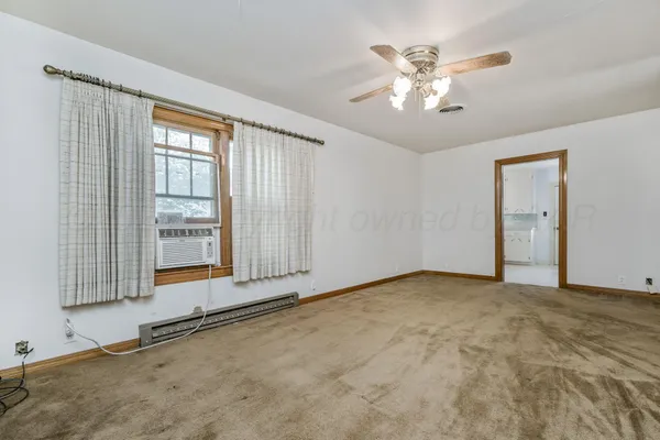 a view of an empty room with a window