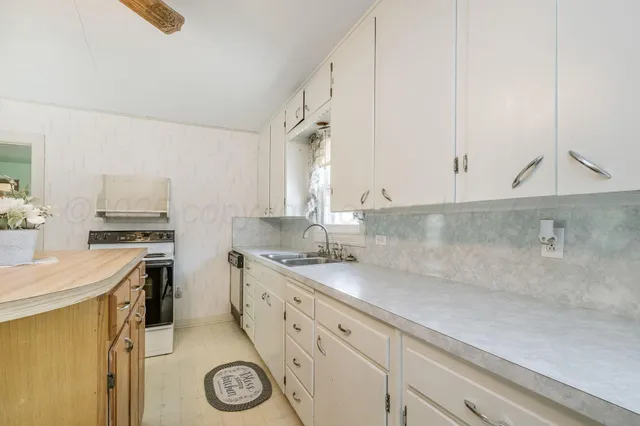 a kitchen with a sink and cabinets