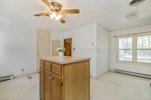 a view of a kitchen with a sink and cabinets