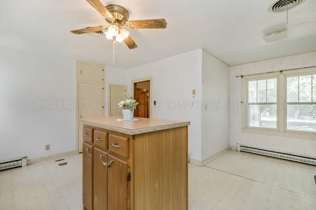 a view of a kitchen with a sink and cabinets