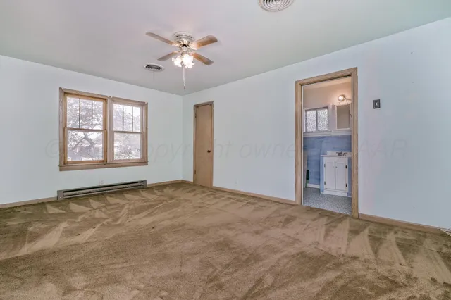 a view of an empty room with a window