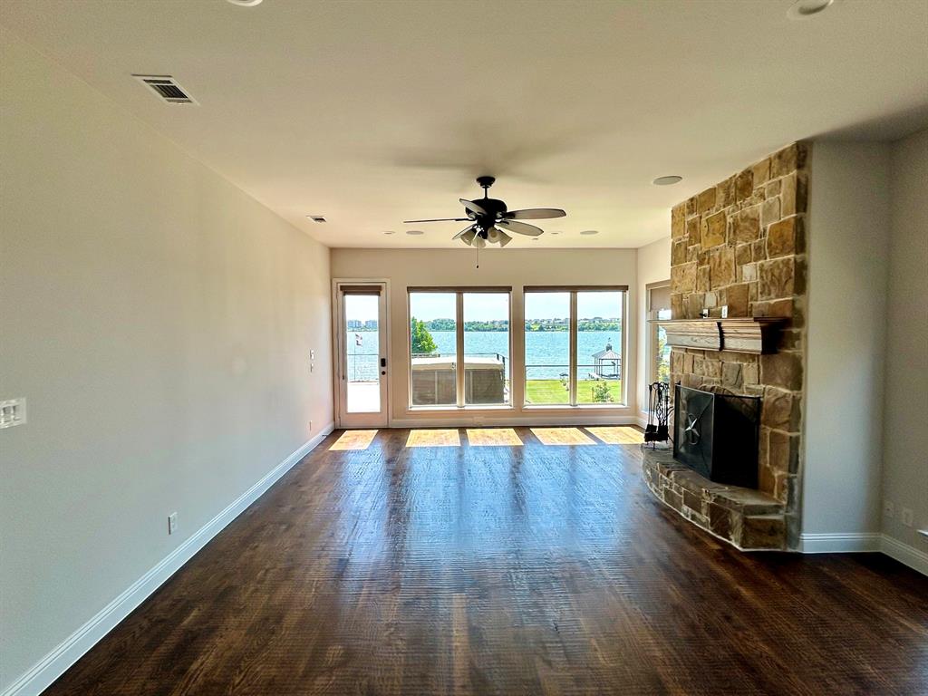 2313 Windjammer Way Rowlett, TX 75088 - Photo 6 of 38 a view of an empty room with wooden floor and a fireplace