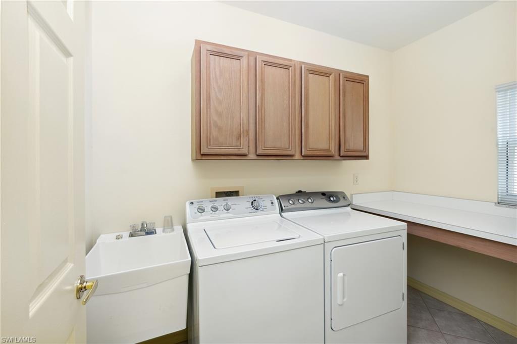 1909 Timarron Way Naples, FL 34109 - Photo 17 of 20 a utility room with dryer and washer