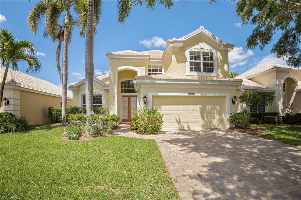 1909 Timarron Way Naples, FL 34109 - Photo 3 of 20 a front view of a house with a yard and potted plants