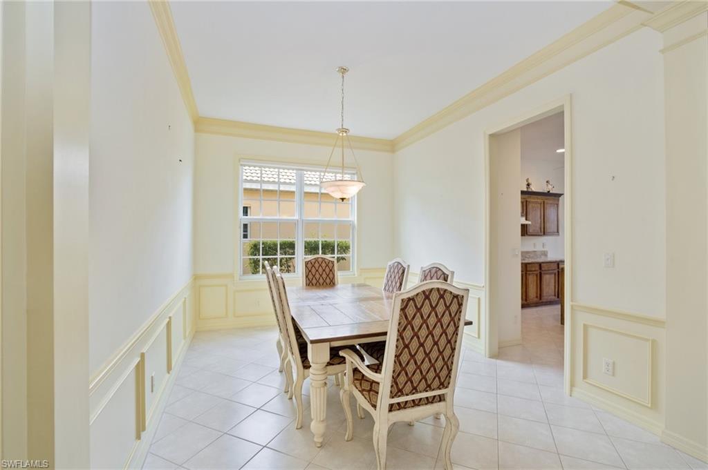 1909 Timarron Way Naples, FL 34109 - Photo 8 of 20 a view of a dining room with furniture and chandelier