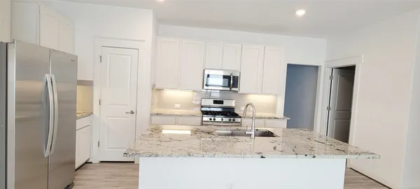 a kitchen with a refrigerator sink and stove