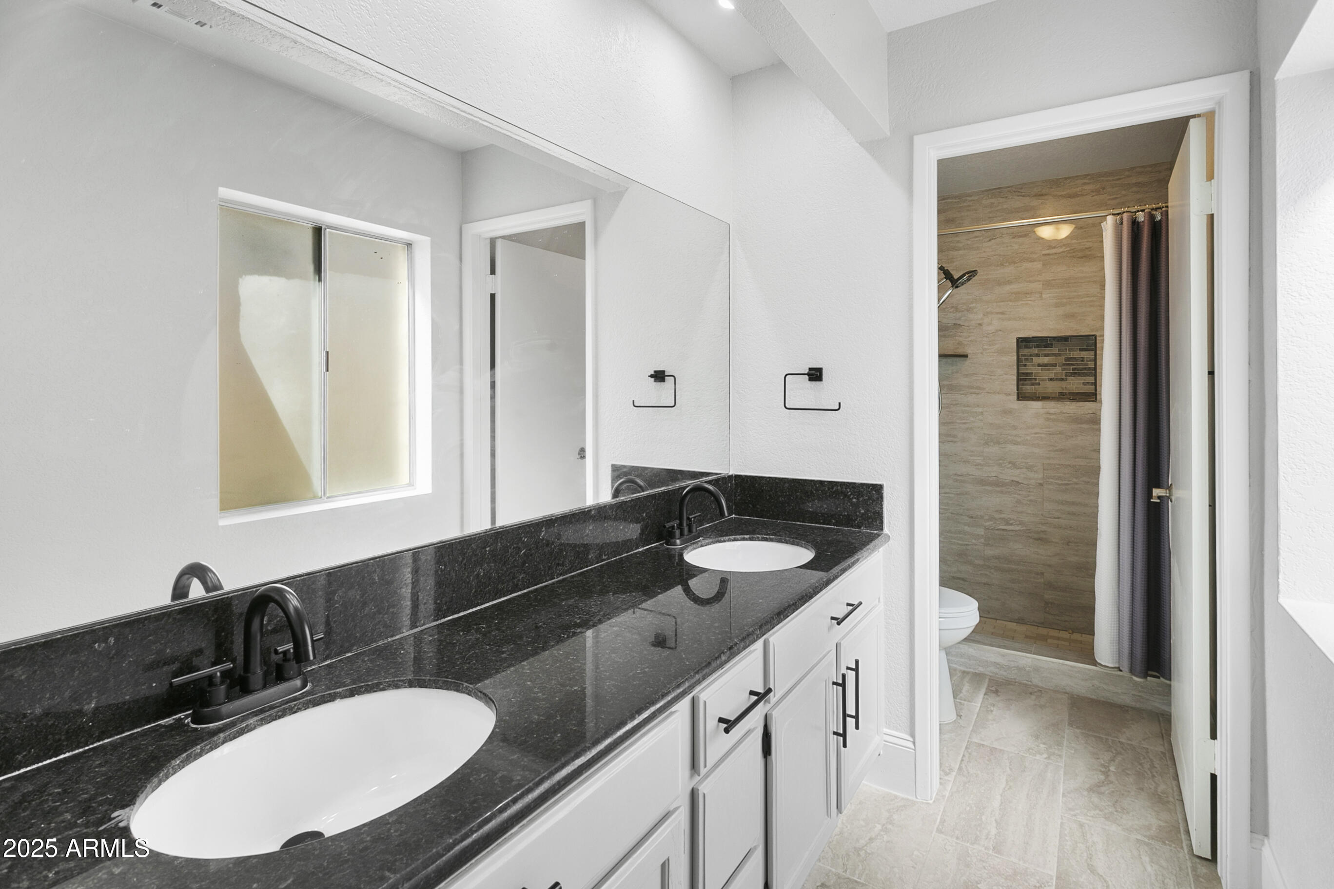 6350 North 78th Street, Unit 290 Scottsdale, AZ 85250 - Photo 17 of 19 a bathroom with a sink double vanity granite and a mirror