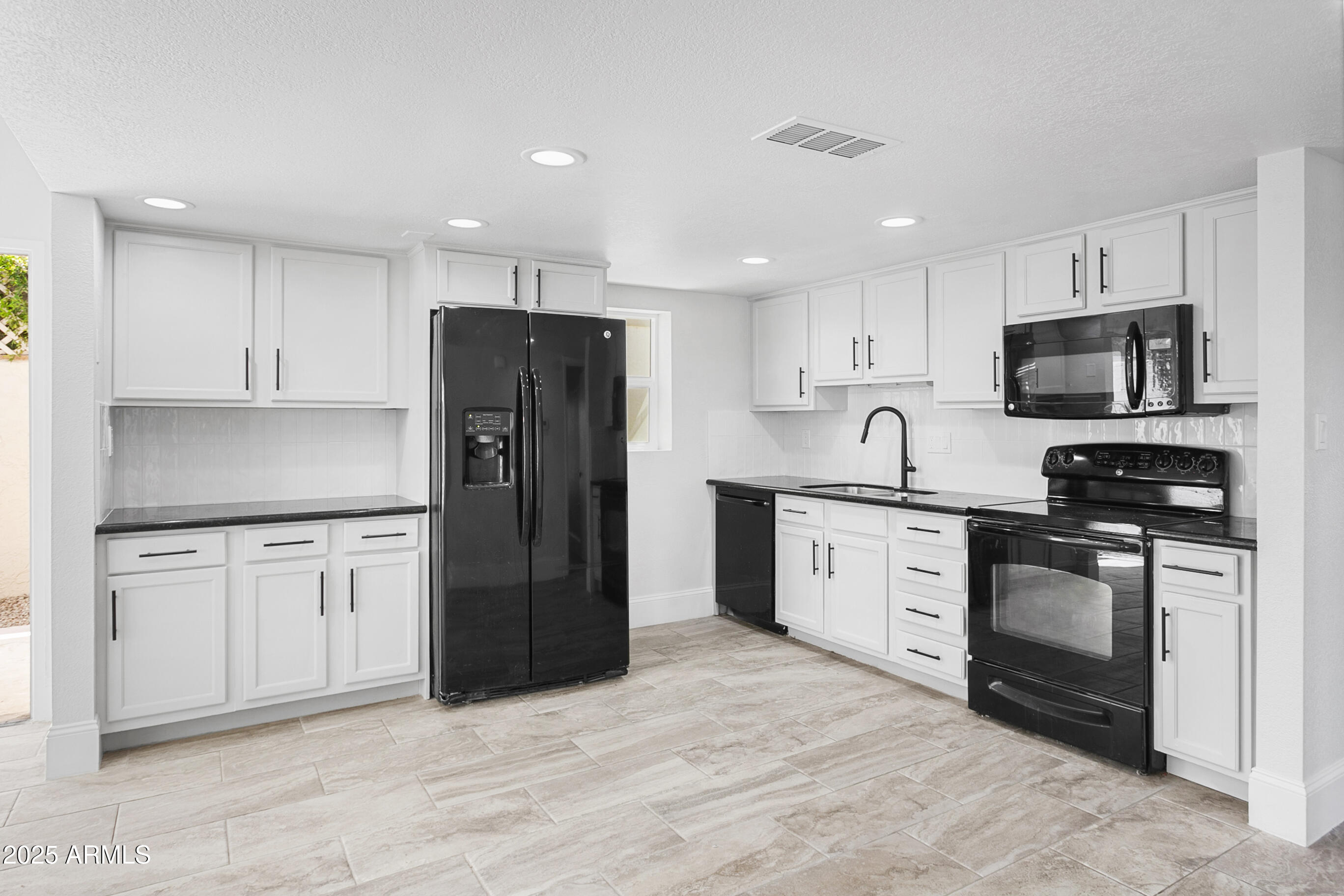 6350 North 78th Street, Unit 290 Scottsdale, AZ 85250 - Photo 7 of 19 a kitchen with stainless steel appliances granite countertop a refrigerator stove microwave and sink