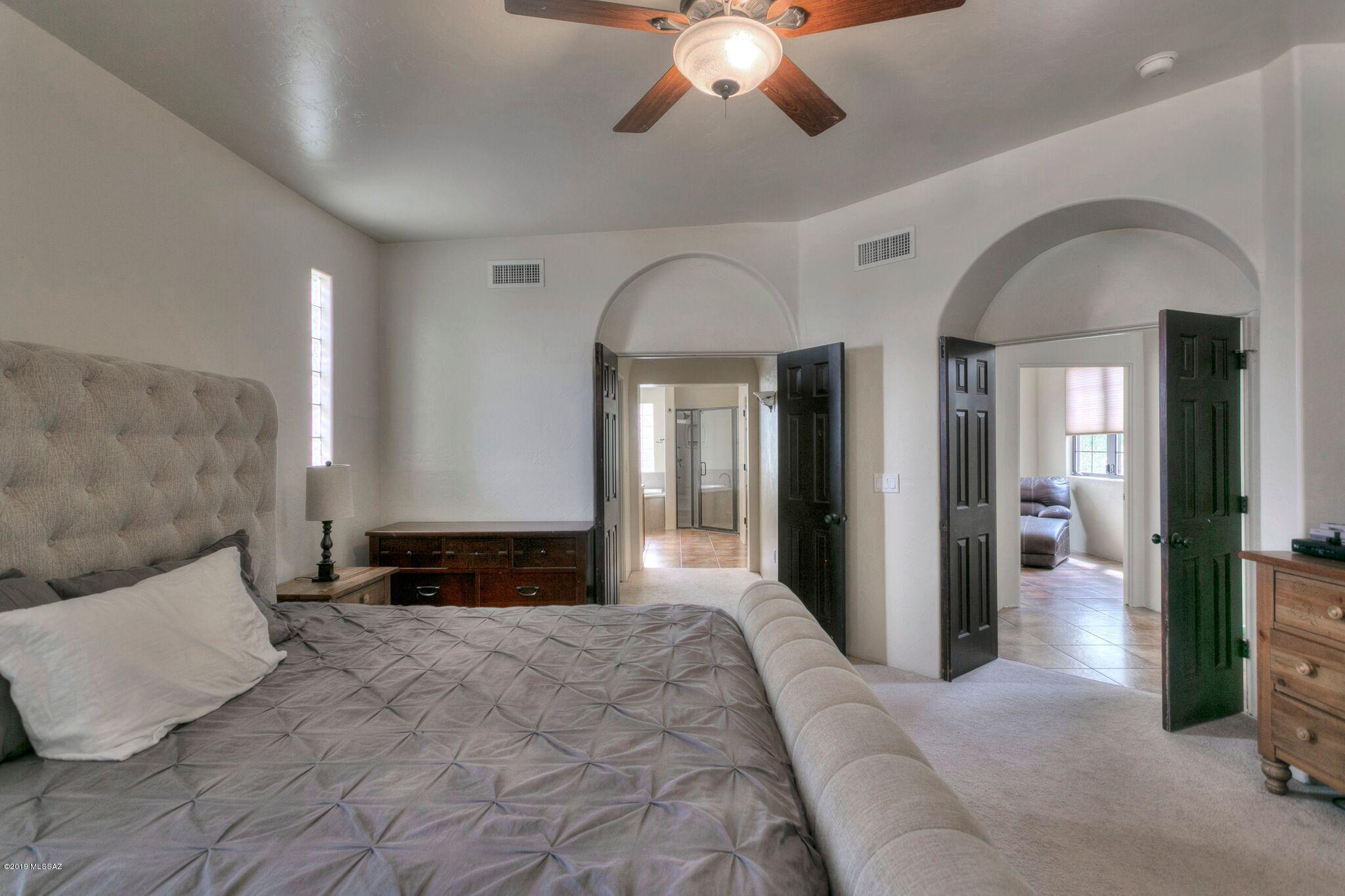 1648 Circulo Puerto Rio Rico, AZ 85648 - Photo 18 of 34 a large bedroom with bed and a chandelier