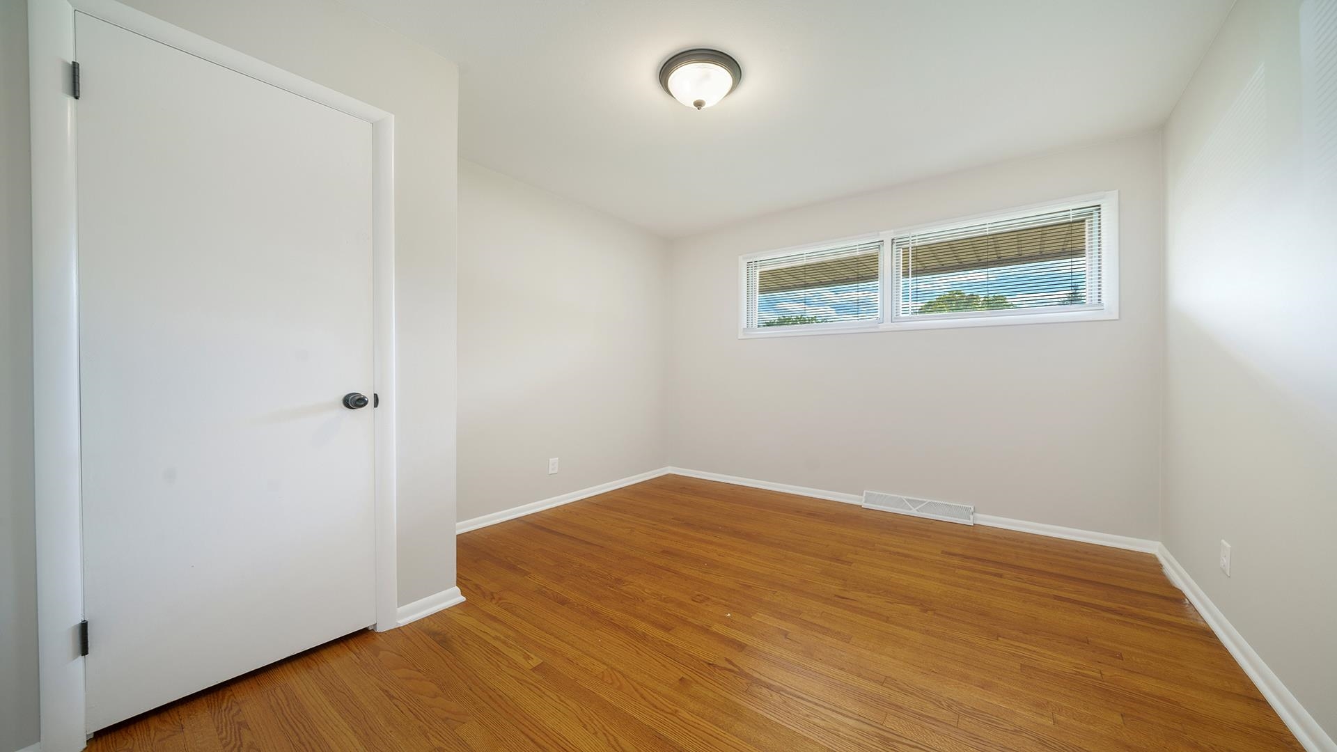 4604 Mohawk Road Rockford, IL 61107 - Photo 12 of 30 an empty room with wooden floor and window
