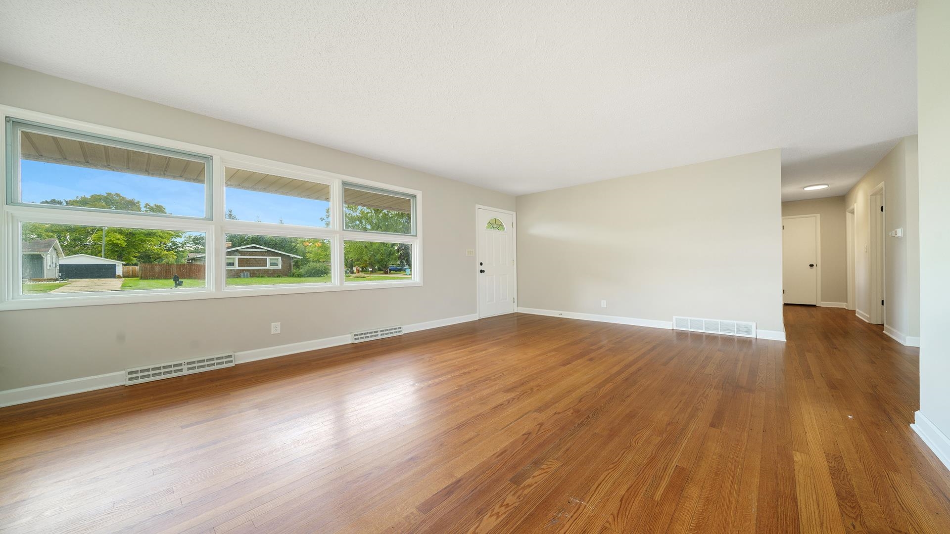 4604 Mohawk Road Rockford, IL 61107 - Photo 3 of 30 an empty room with wooden floor and windows