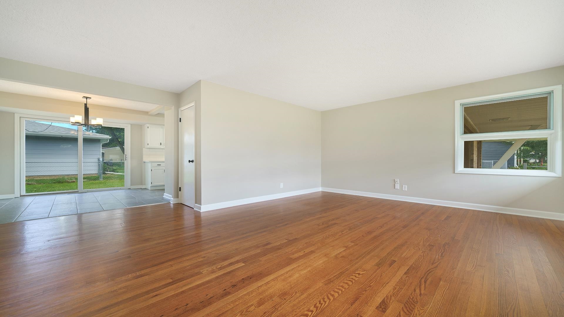 4604 Mohawk Road Rockford, IL 61107 - Photo 4 of 30 an empty room with wooden floor and windows
