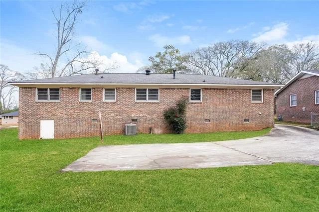 a front view of a house with a garden and yard