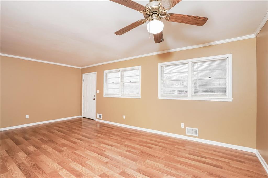 1320 North Cherokee Avenue Griffin, GA 30224 - Photo 3 of 20 a view of an empty room with wooden floor and a window