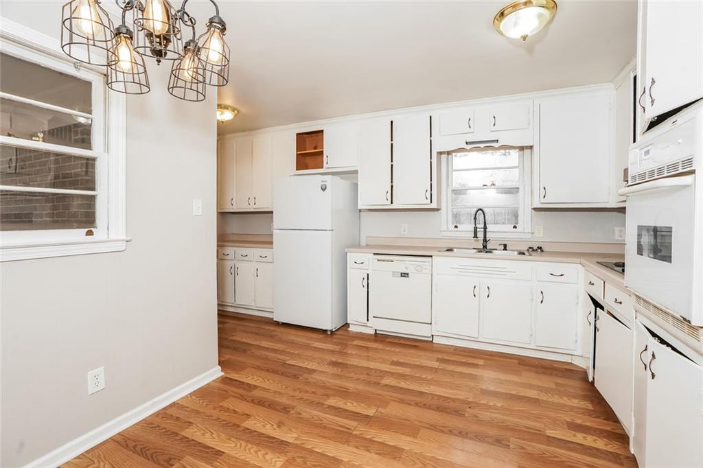 1320 North Cherokee Avenue Griffin, GA 30224 - Photo 5 of 20 a kitchen with white cabinets and white appliances