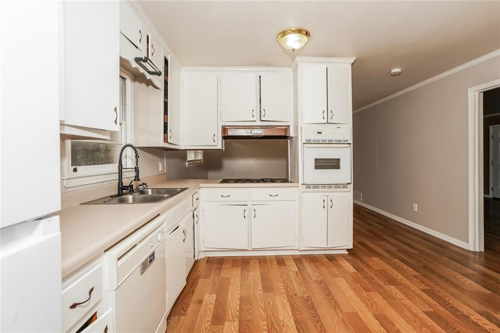1320 North Cherokee Avenue Griffin, GA 30224 - Photo 8 of 20 a kitchen with a sink stove and cabinets