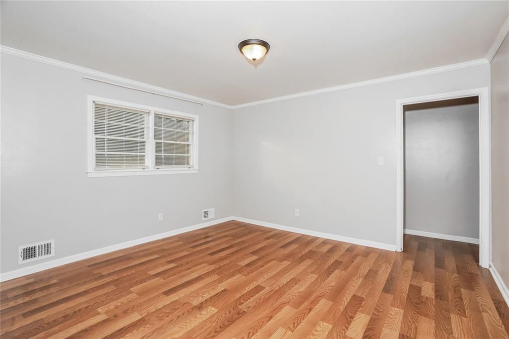 1320 North Cherokee Avenue Griffin, GA 30224 - Photo 10 of 20 a view of empty room with wooden floor and fan