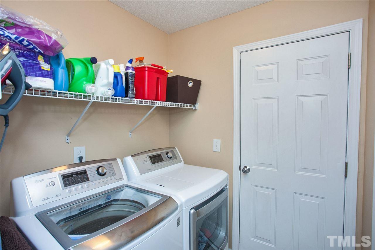 6838 Harter Court Raleigh, NC 27610 - Photo 16 of 25 Great Laundry Room ... plenty of space to process the laundry ... shelving for storage ... room to store other items!