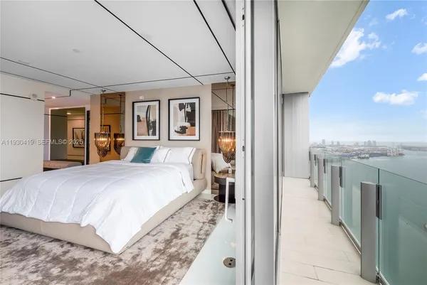 a bedroom with a large bed and a walk in closet