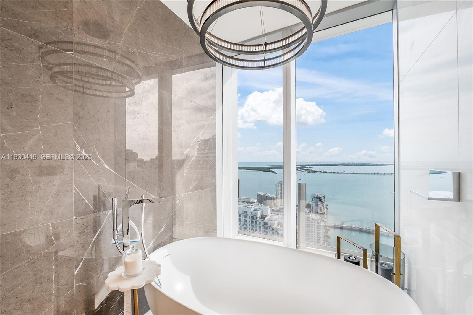 300 Biscayne Blvd Way, Unit 5104 Miami, FL 33131 - Photo 16 of 35 a bathroom with a bathtub and a window