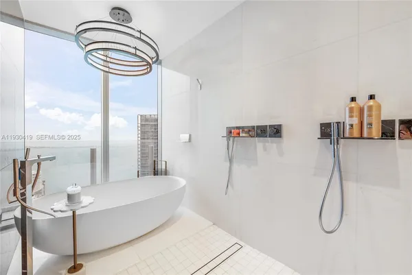 a bathroom with a bathtub and shower