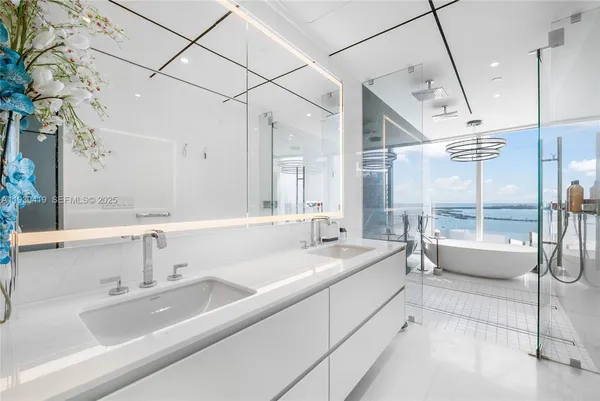 a bathroom with a sink and a large mirror