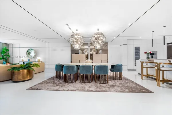 a room with lots of wooden furniture and view of chandelier