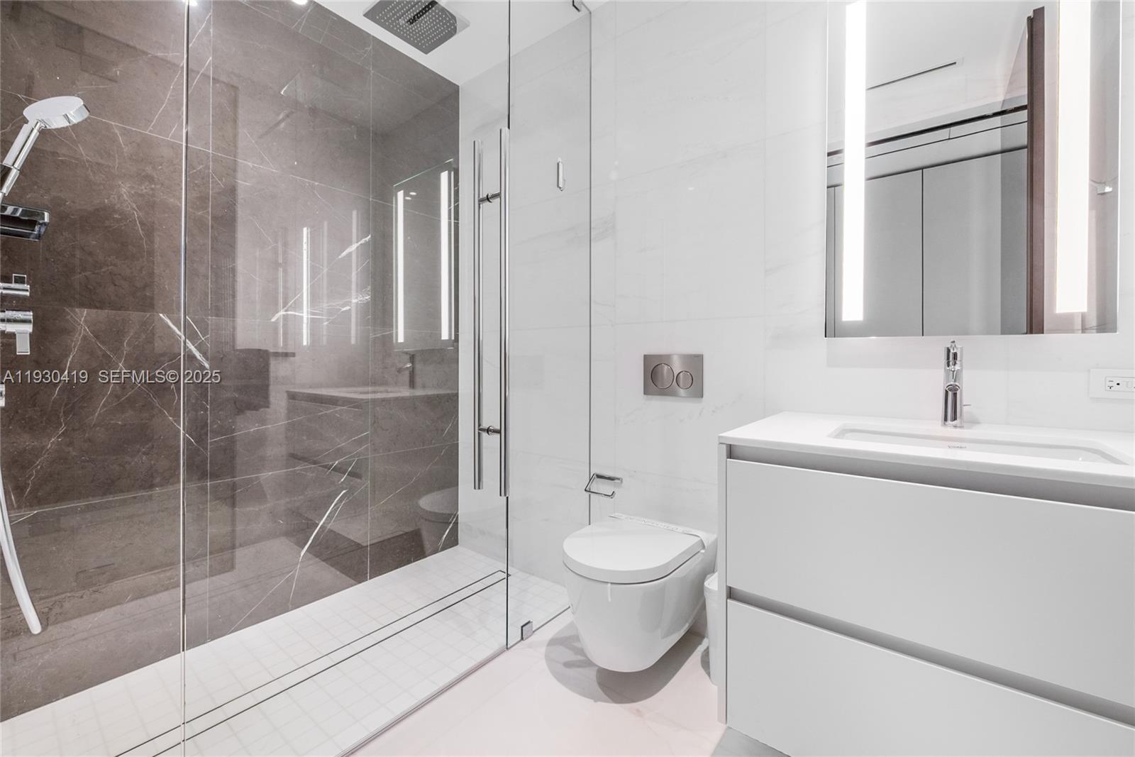 300 Biscayne Blvd Way, Unit 5104 Miami, FL 33131 - Photo 28 of 35 a bathroom with a sink toilet and shower