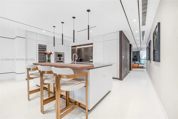 a kitchen with stainless steel appliances a stove a refrigerator and a fireplace