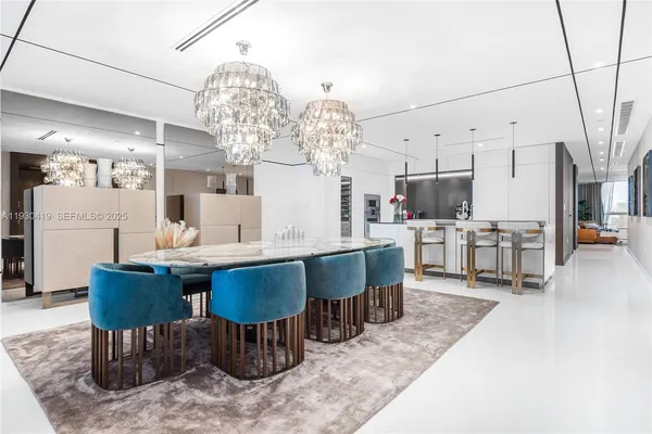 a large kitchen with a table and chairs