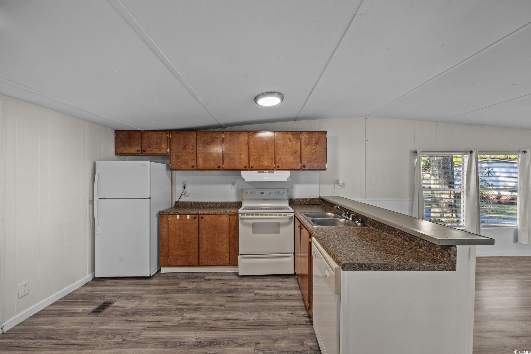 173 Braddock Court Murrells Inlet, SC 29576 - Photo 11 of 30 Kitchen with dark wood-type flooring, sink, lofted