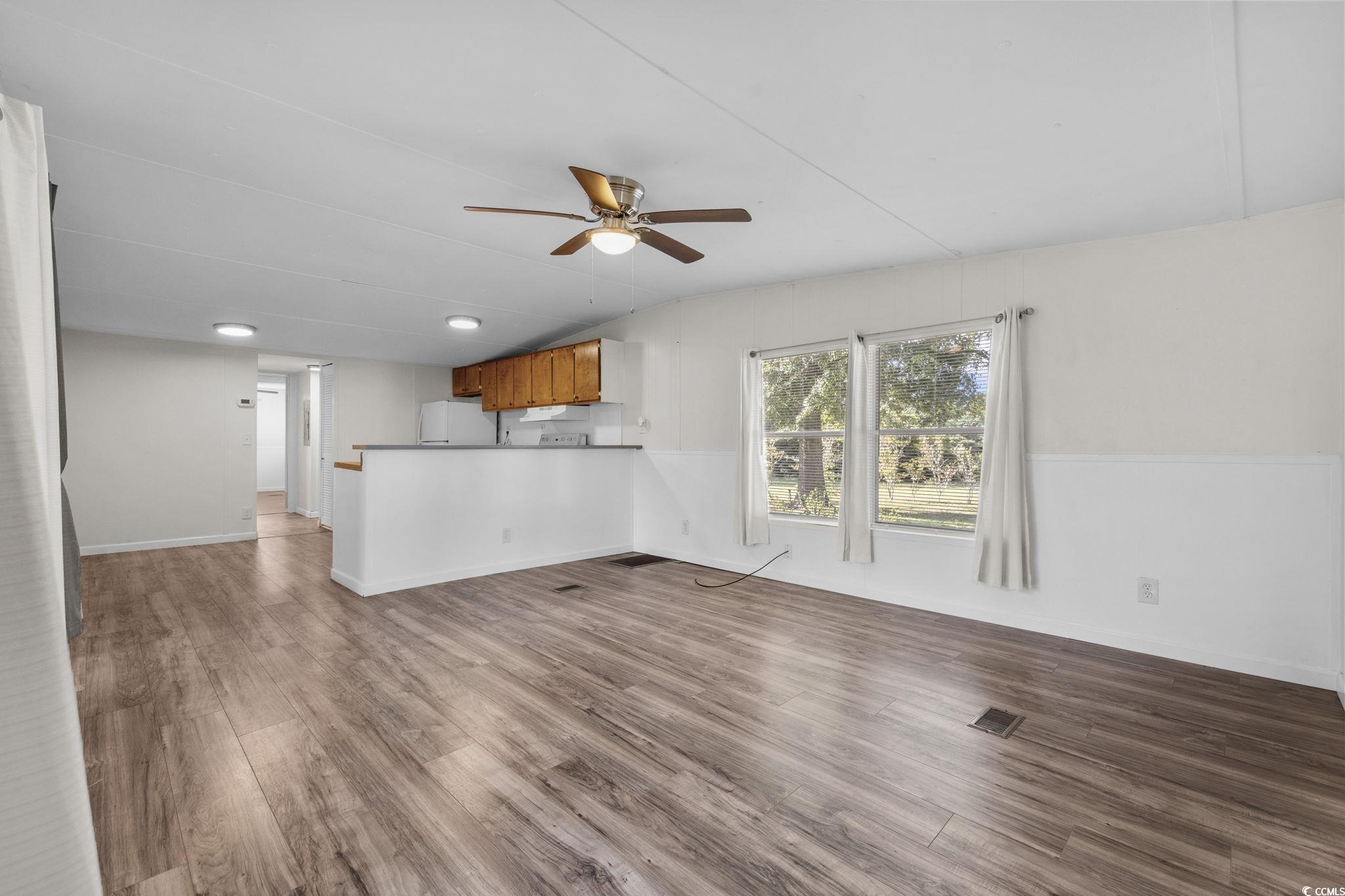 173 Braddock Court Murrells Inlet, SC 29576 - Photo 14 of 30 Unfurnished living room with dark hardwood / wood-