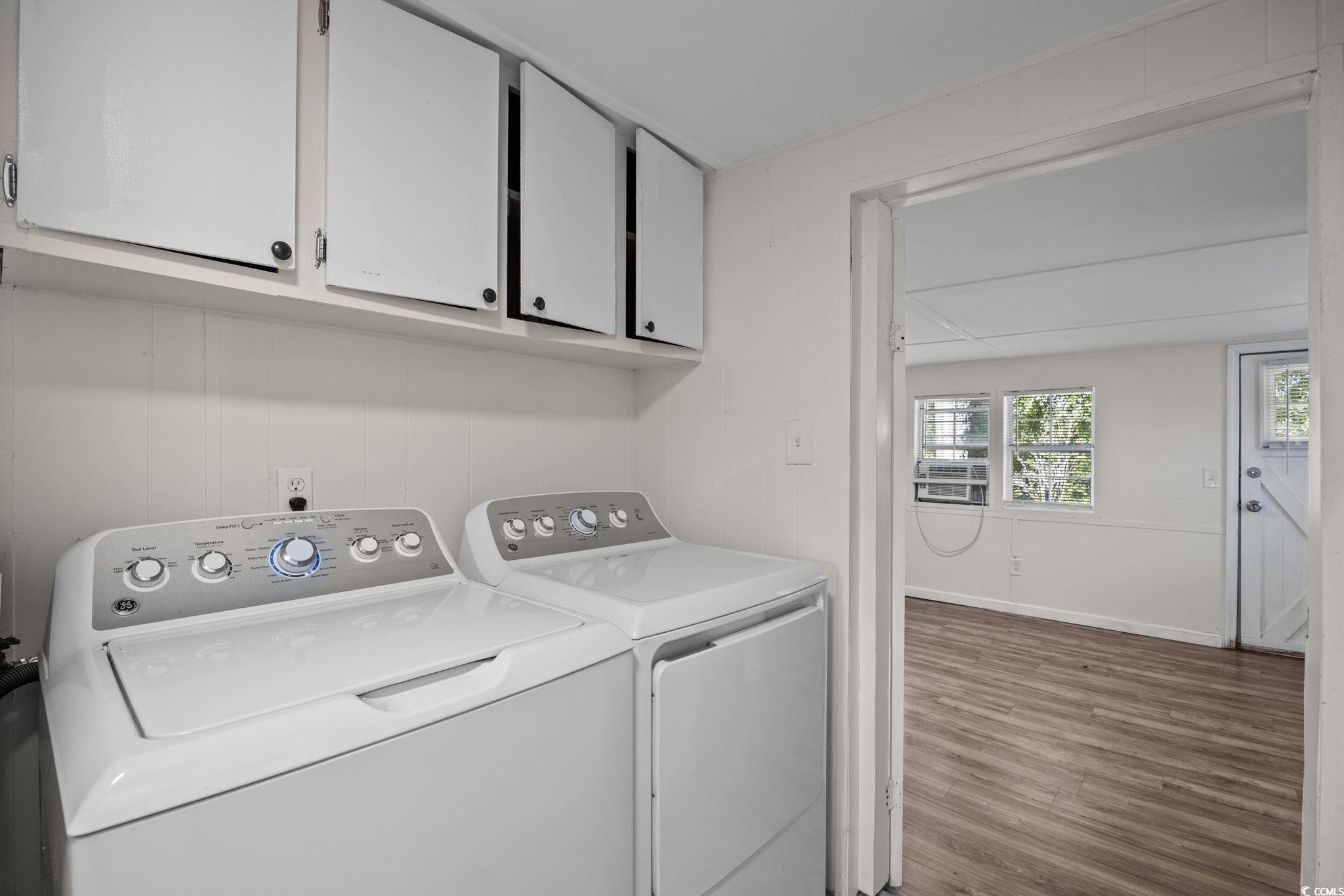 173 Braddock Court Murrells Inlet, SC 29576 - Photo 24 of 30 Washroom with wood-type flooring, cabinets, and in