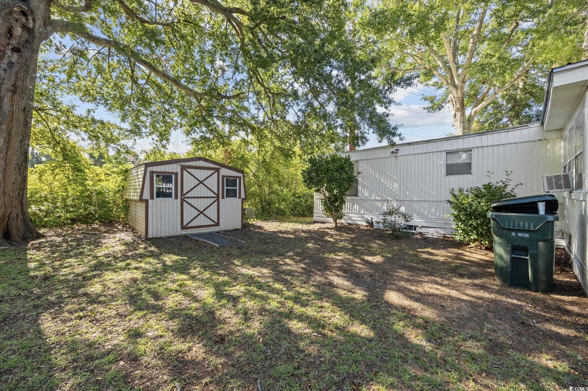 173 Braddock Court Murrells Inlet, SC 29576 - Photo 25 of 30 View of yard featuring a storage shed and cooling