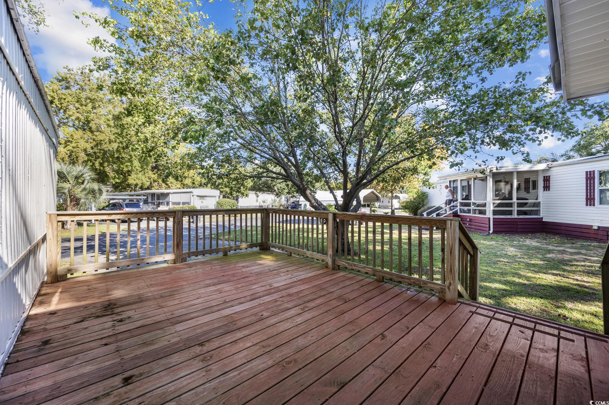 173 Braddock Court Murrells Inlet, SC 29576 - Photo 5 of 30 Deck with a sunroom and a lawn