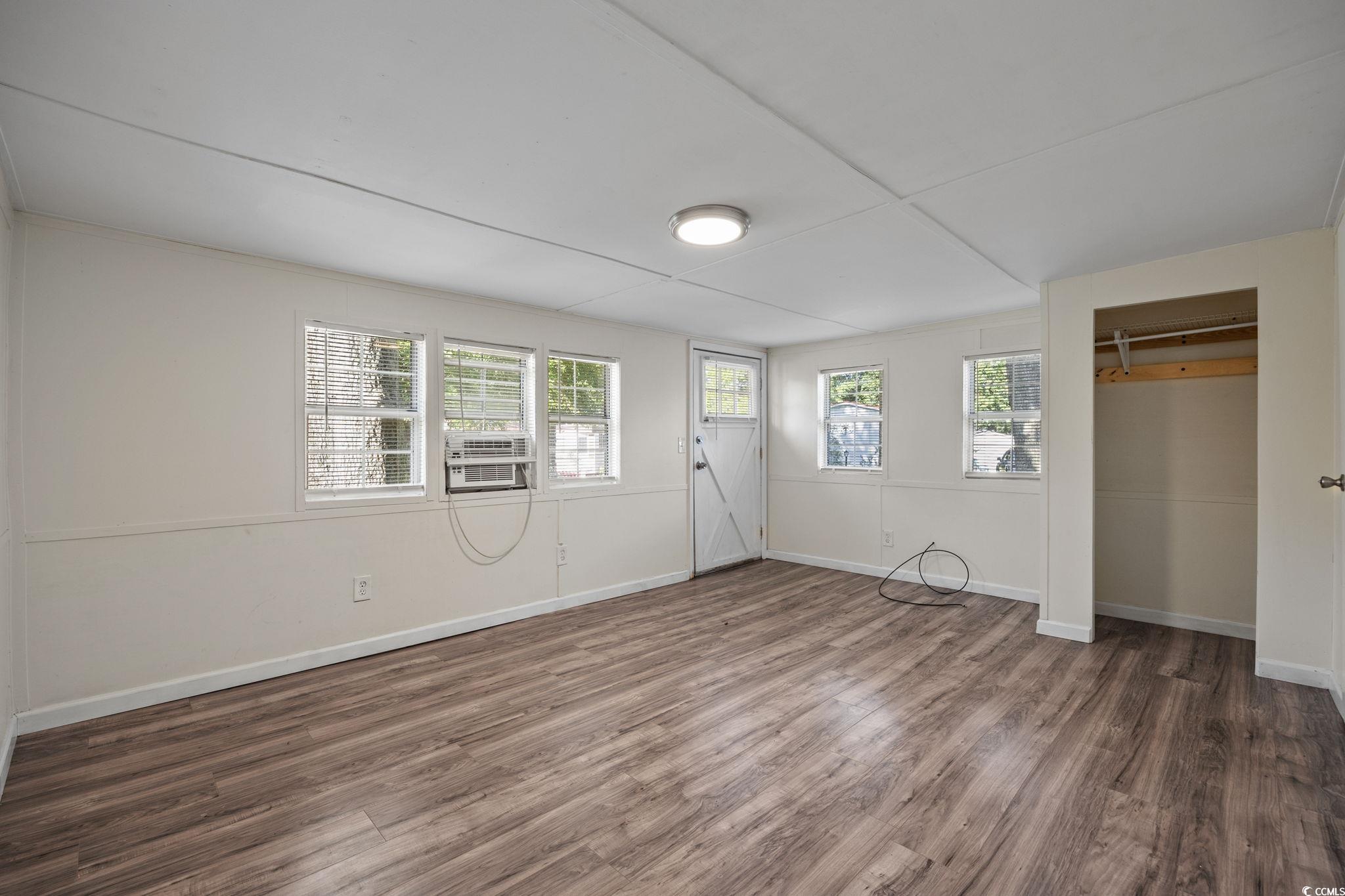 173 Braddock Court Murrells Inlet, SC 29576 - Photo 8 of 30 Unfurnished room featuring cooling unit, dark wood