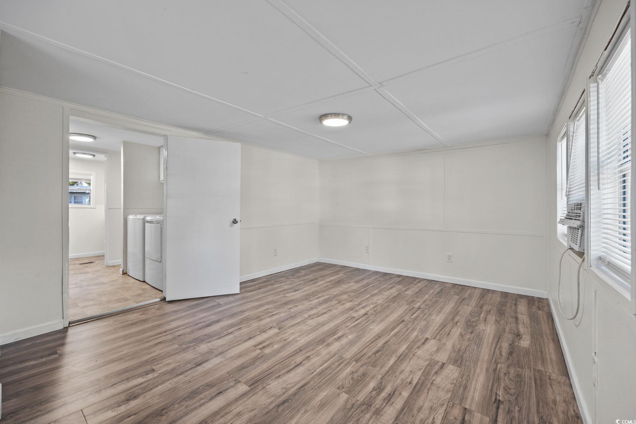 173 Braddock Court Murrells Inlet, SC 29576 - Photo 9 of 30 Unfurnished room featuring wood-type flooring and