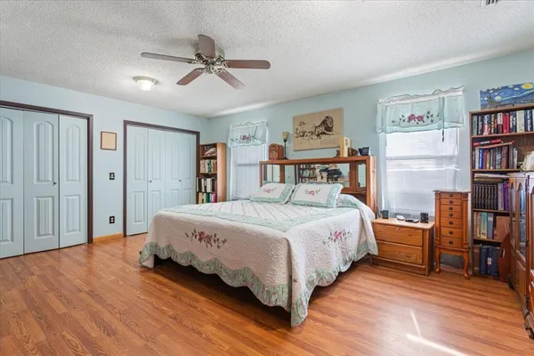 a bedroom with a bed and a book shelf
