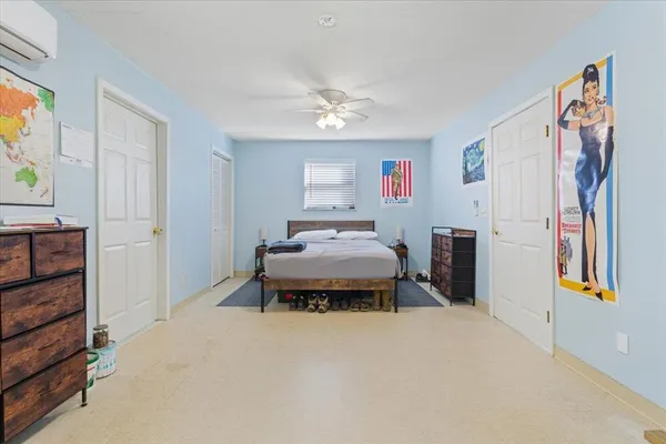 a bedroom with furniture and a chandelier