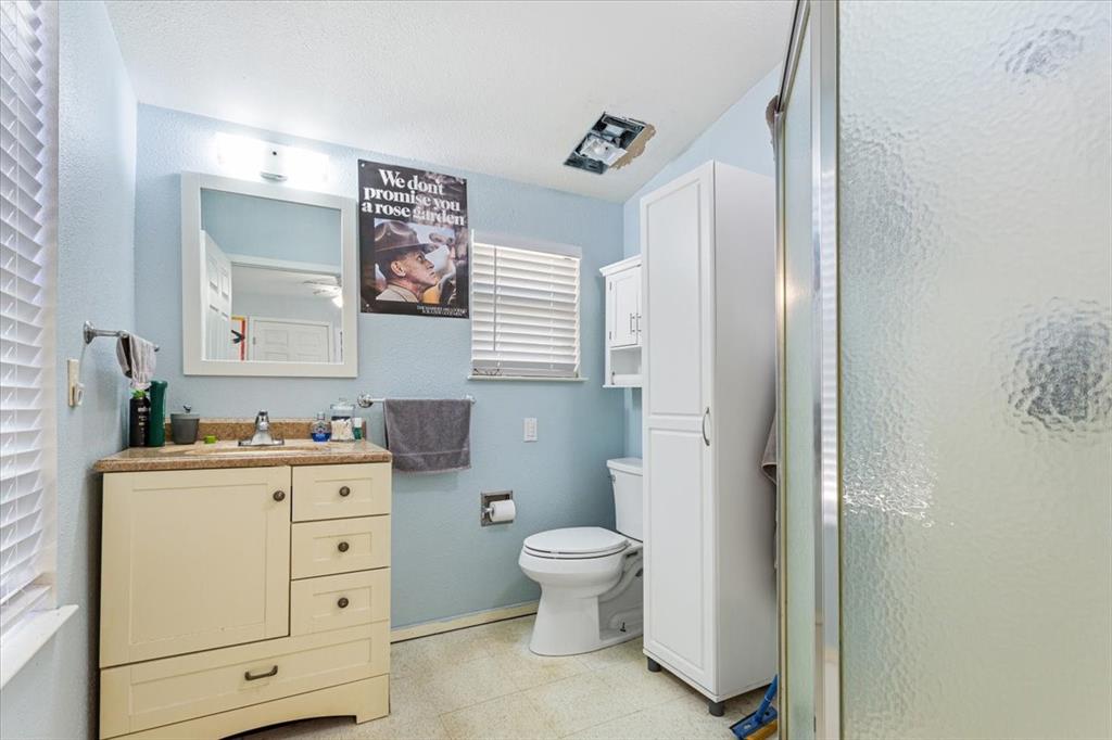 290 Fcr, Unit 481 Teague, TX 75860 - Photo 17 of 33 a bathroom with a toilet a sink a mirror a vanity and window