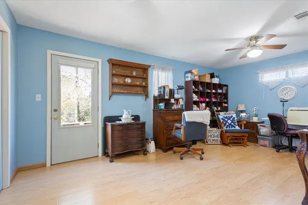 a view of a workspace with furniture and a window