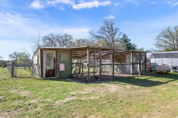 a view of a house with yard and sitting area