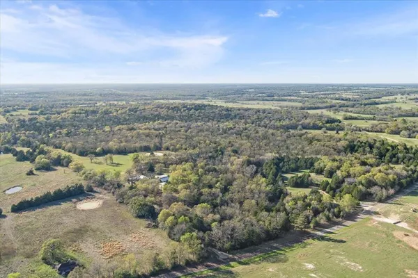 an aerial view of a houses with a lake