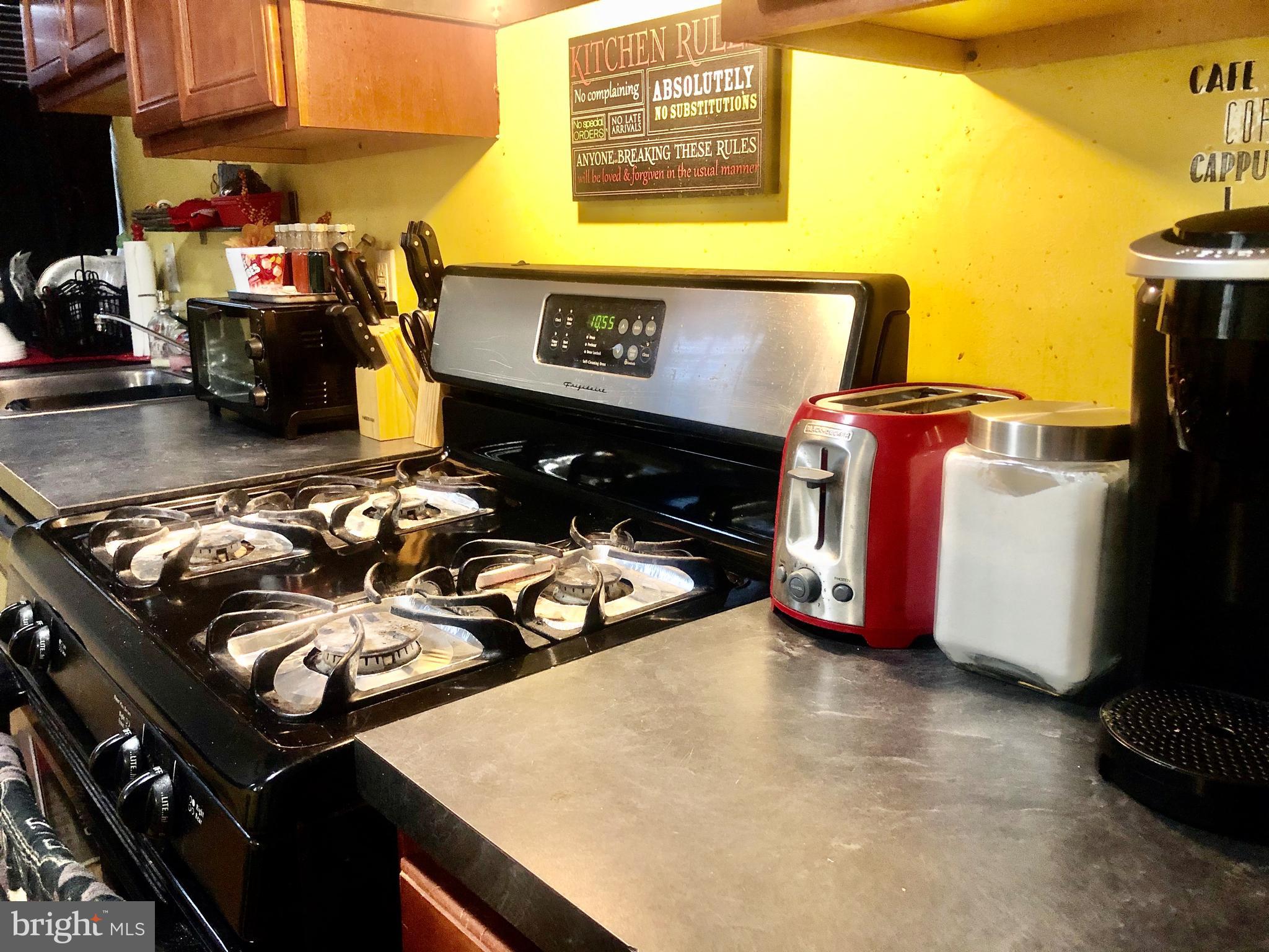 1581 Minnesota Road Camden, NJ 08104 - Photo 8 of 16 a kitchen with a stove and a refrigerator