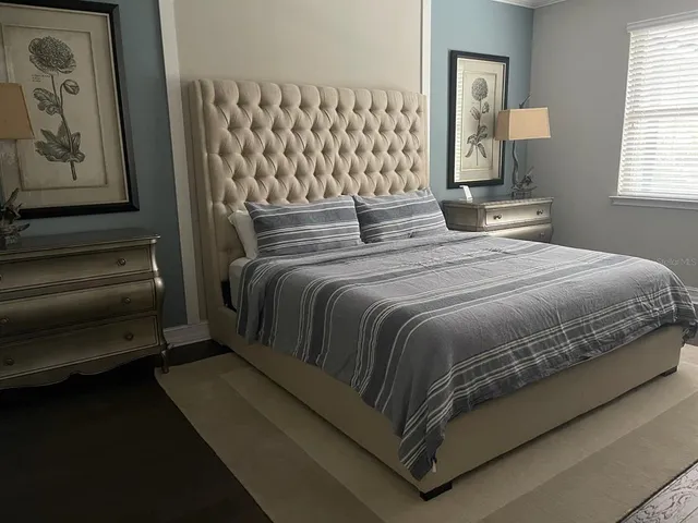 a bedroom with a bed and window
