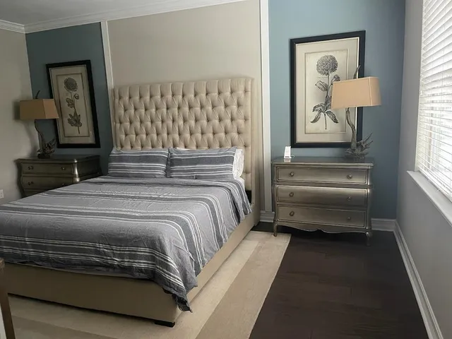 a bedroom with a bed and a chandelier